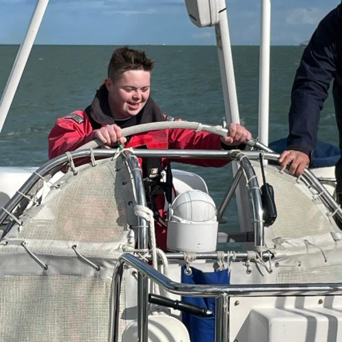 Boy steering with big smile