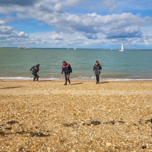 three people on cowes beach