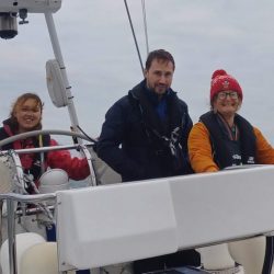 three people at the helm