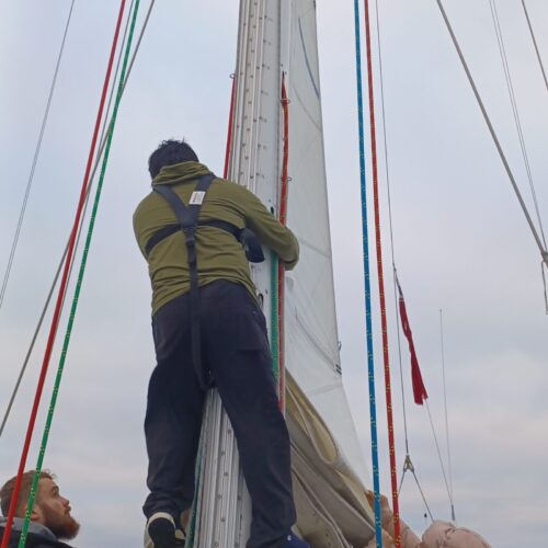 young person climbing the mast