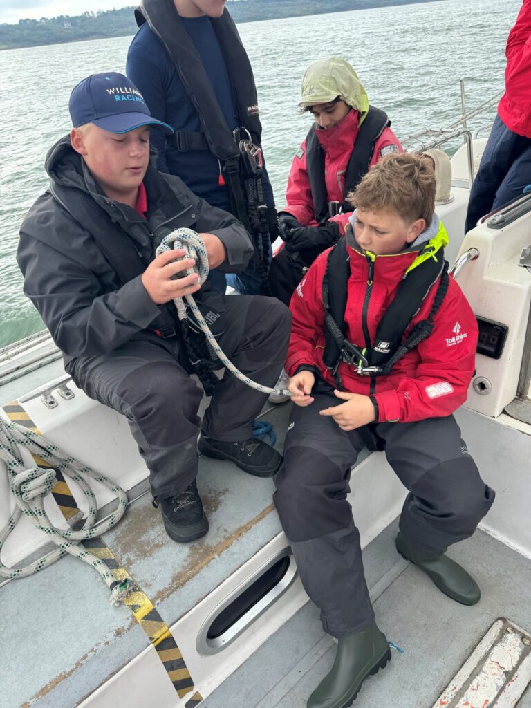 Two boys learning knots on a Challenger