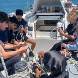 young people sailing and tying knots