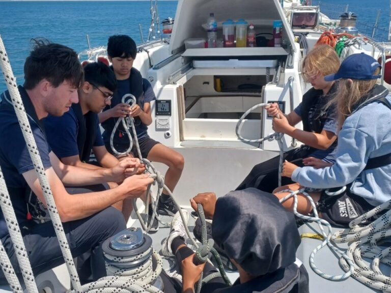 young people sailing and tying knots